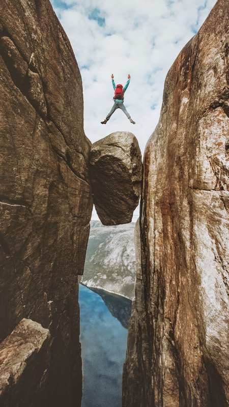 Kjerag, Western Norway — Iconic mountain peak with Kjeragbolten boulder, challenging hike with chains.